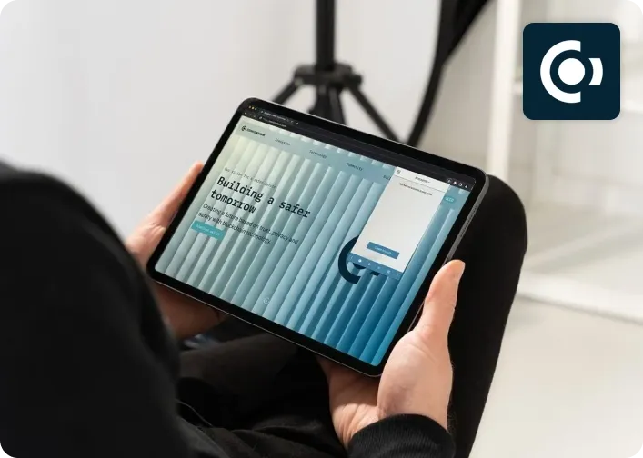A person holding a tablet showing the Concordium website.